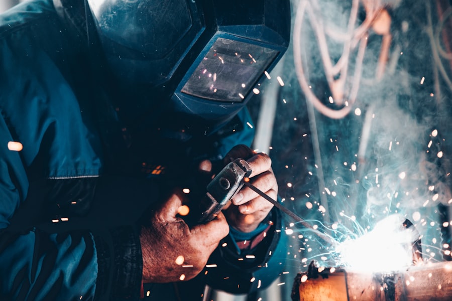A welder at work wearing protective equipment