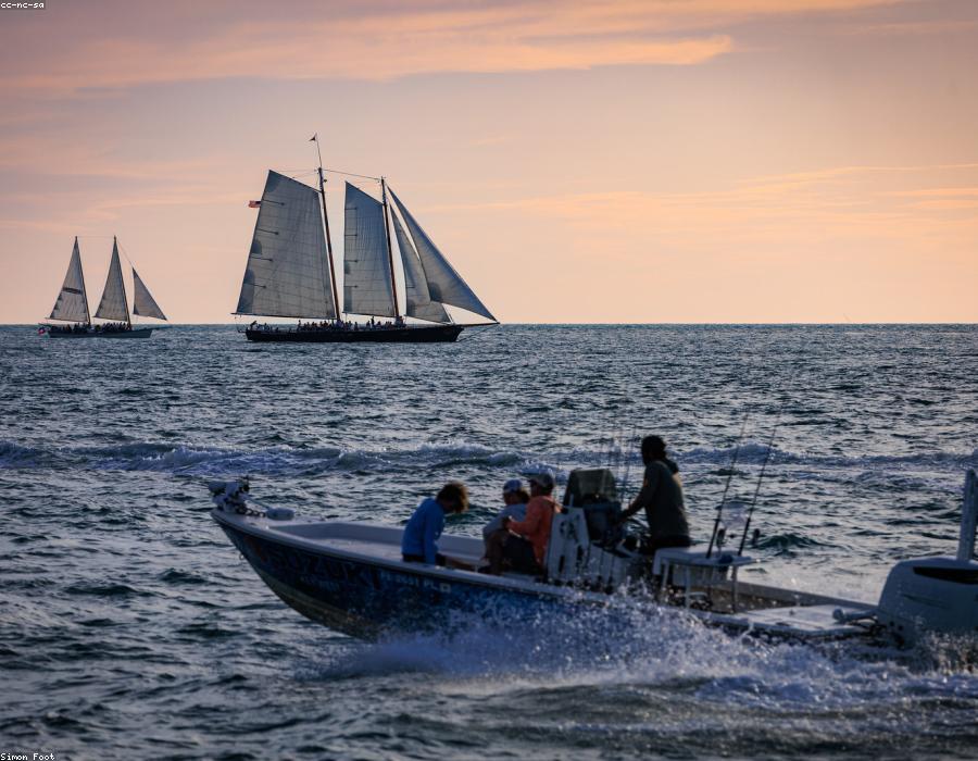 People enjoying a boat on the water at sunset